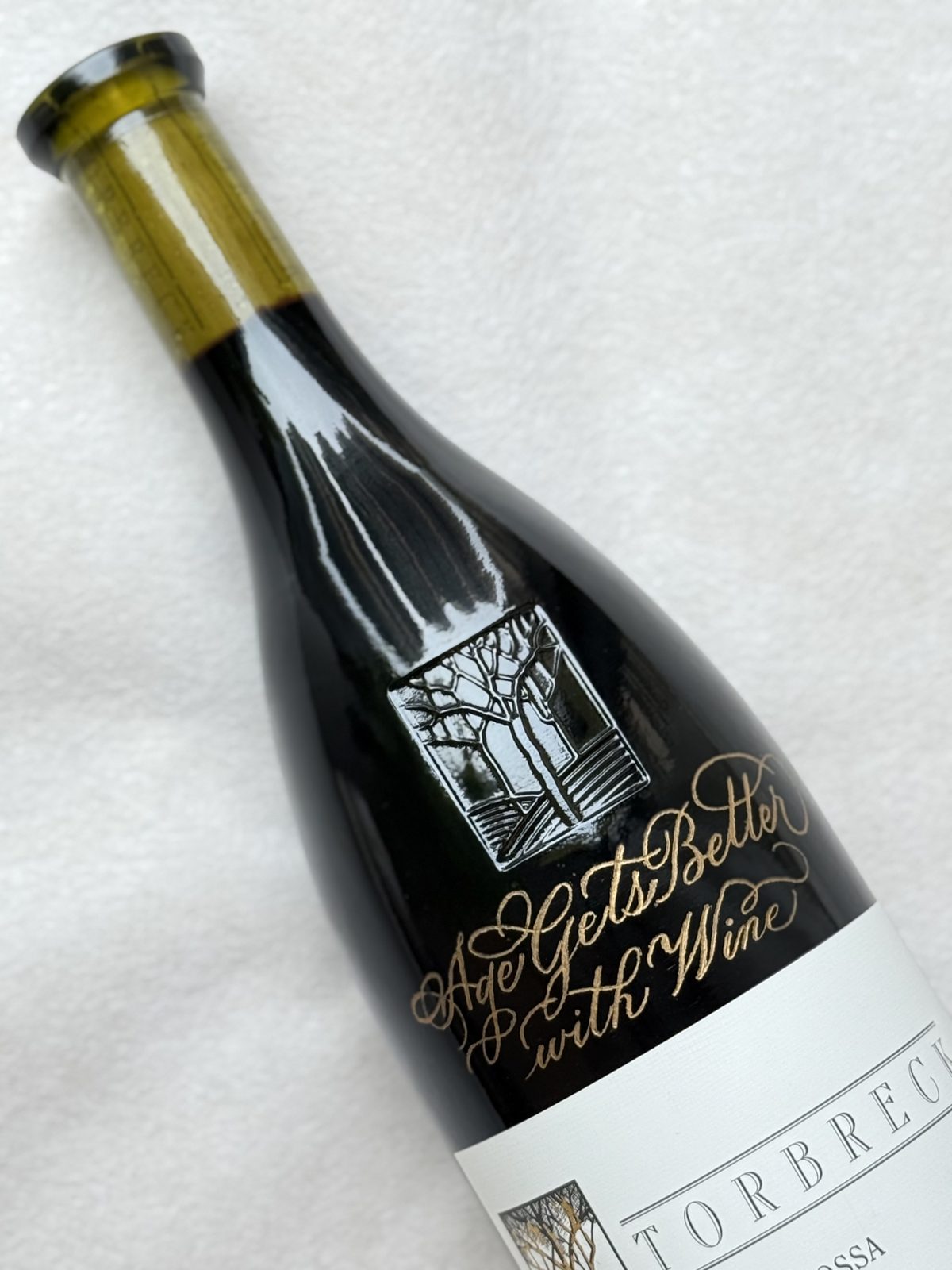 Wine bottle engraved with a gold calligraphed gifting message