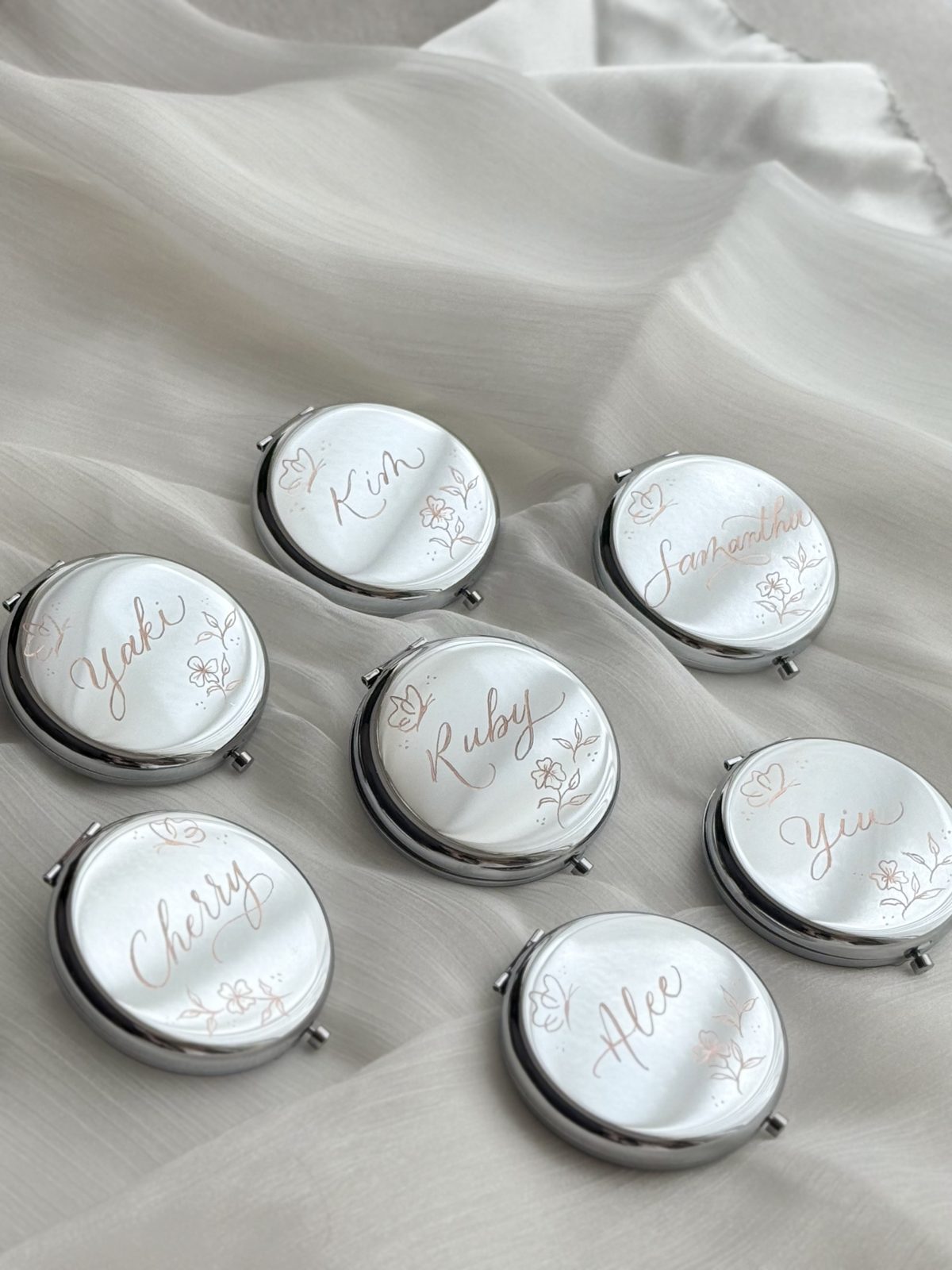 Set of silver compact mirrors engraved with individual guest names