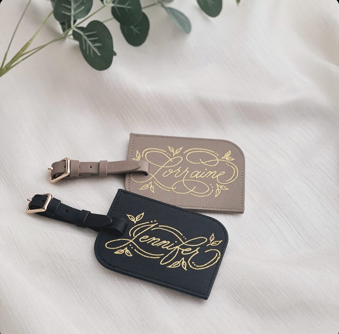 Leather luggage tags hot foiled with flourished gold calligraphy names