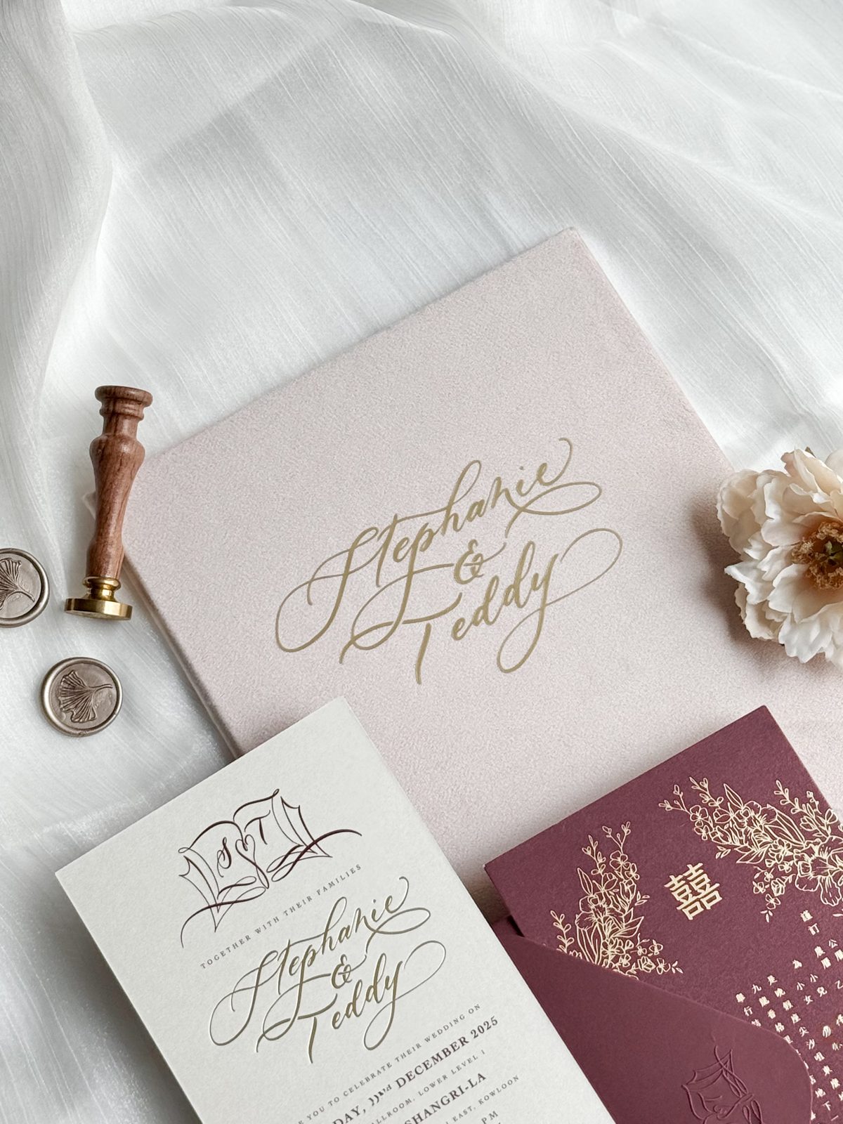 Blush and burgundy wedding invitation suite with gold wax seal and calligraphed names