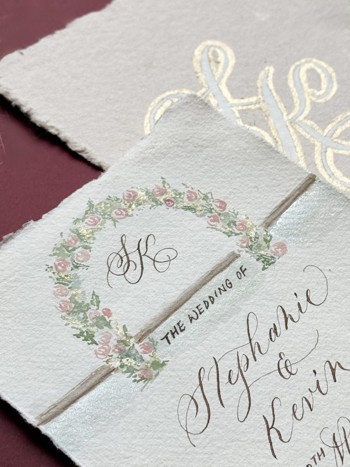 Handmade paper wedding certificate with painted floral wreath and calligraphed names