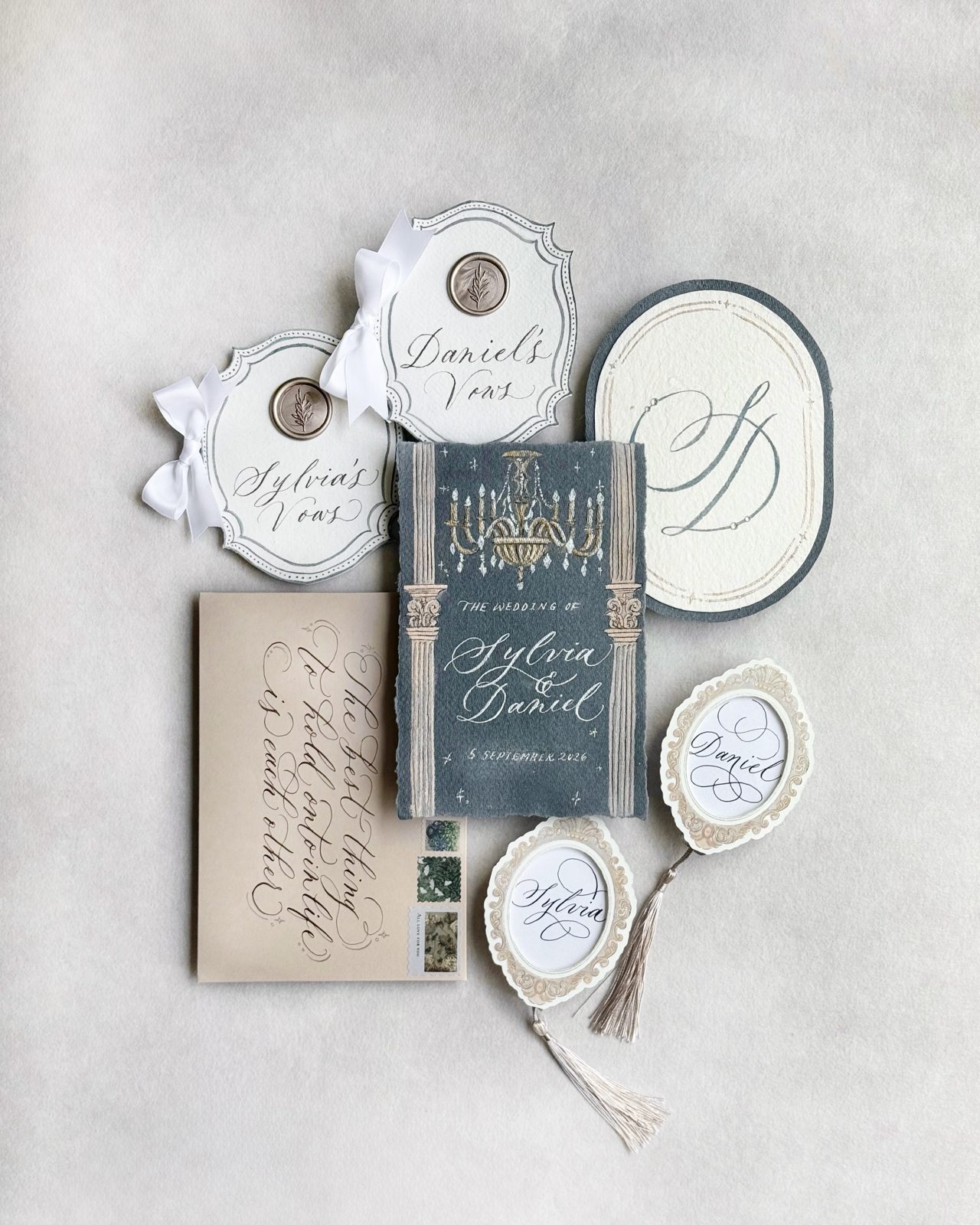 Collection of calligraphed wedding keepsakes including agate tags and mirrored cards